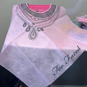 Too Faces disposable makeup bibs. I have 2 packages of 10 bibs each.